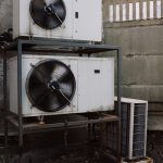 External units of air conditioner placed on metal board near wall